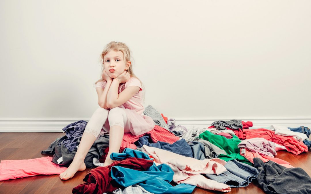 kid with cluttered clothes